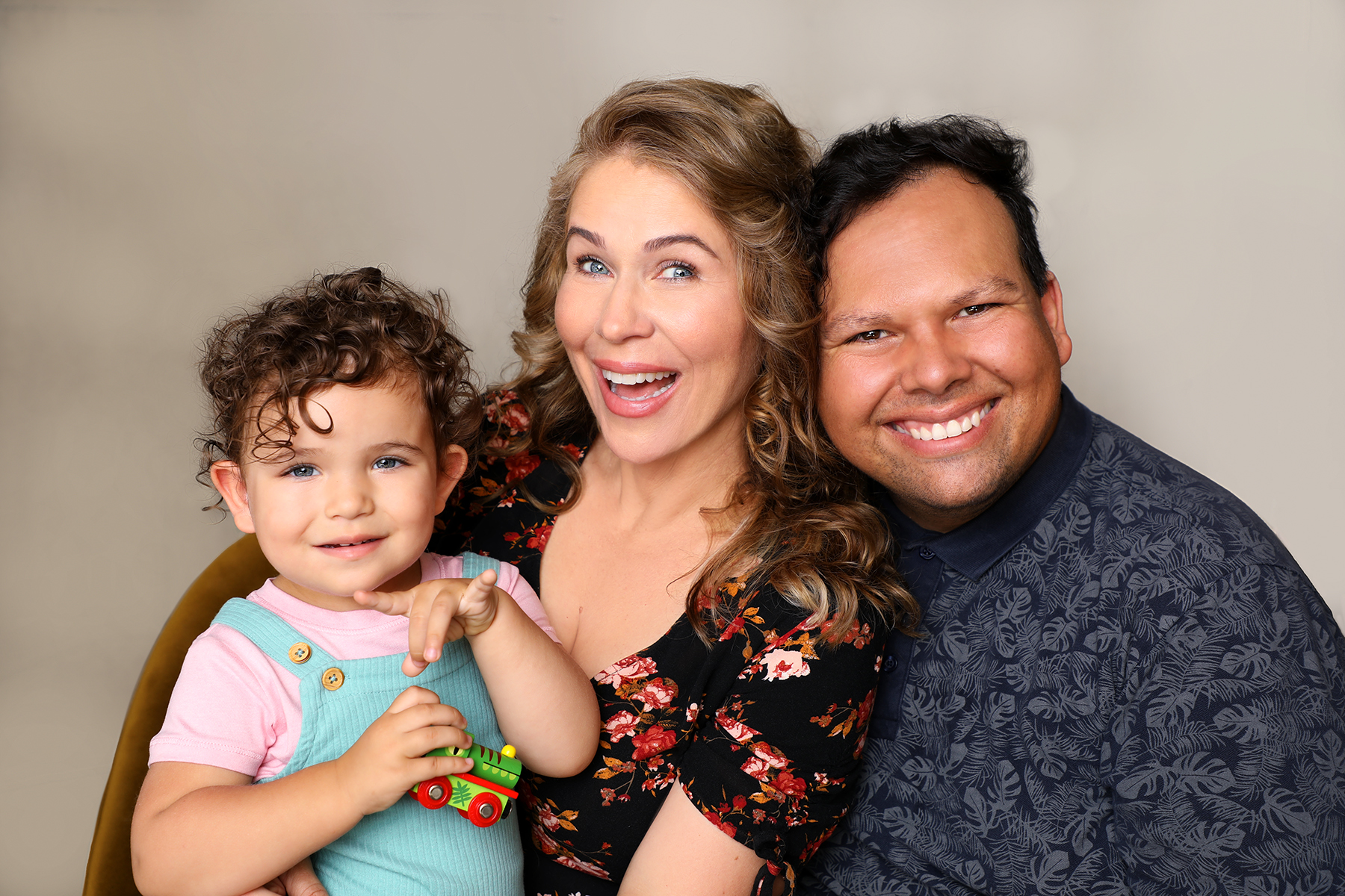 A real GOP-library family — two parents joyfully holding a toddler — adds authentic representation of what employer fertility benefits can make possible, balancing the stock imagery in the other picks.